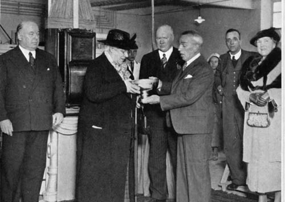 Miss E. Aitken being presented with a rose bowl at the opening of the new bottling hall in 1938.