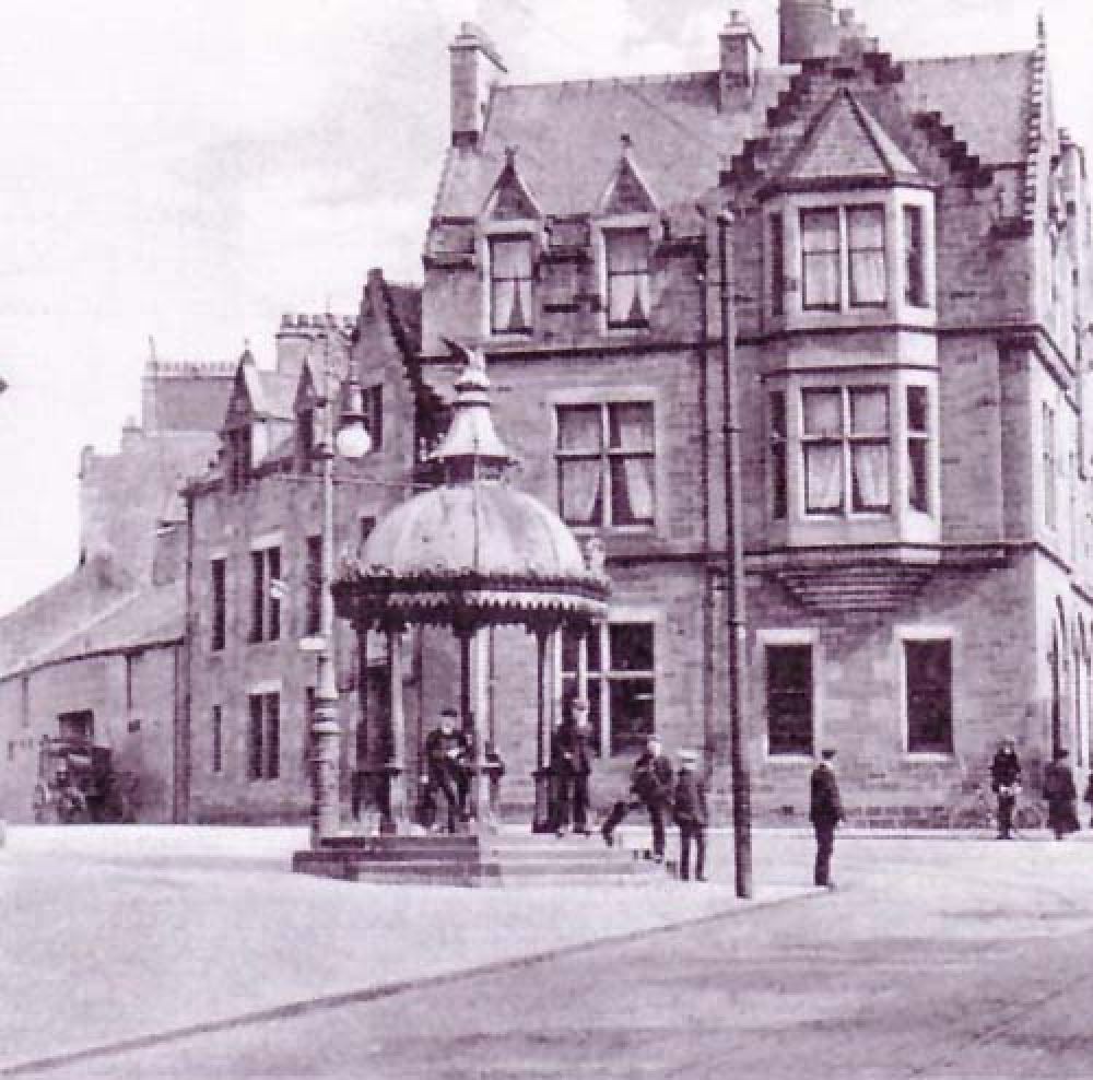 A view along Newmarket Street from the west showing the brewery at the left, where a coach is parked. © Forbes Gibb, 2016