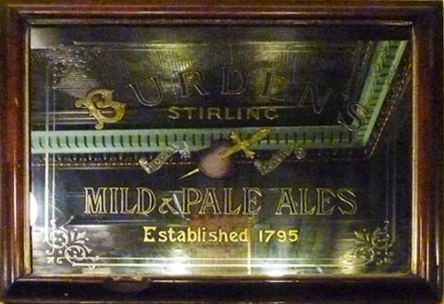<p>A mirror advertising Peter Burden's Pale and Mild Ales, and featuring a trademark of a heart with a dagger through it.</p>